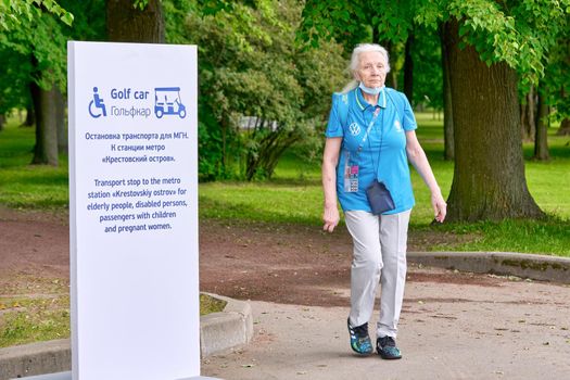Saint Petersburg, Russia - June 12, 2021: elderly volunteer of the Euro 2020 championship nearZenit stadium Petersburg