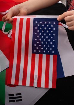 Child hand holding an American national flag in hand