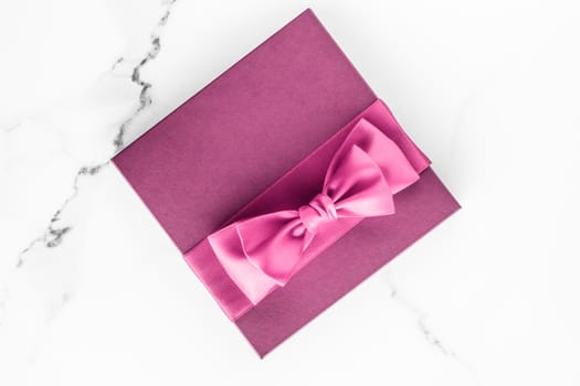 Birthday, wedding and girly branding concept - Pink gift box with silk bow on marble background, girl baby shower present and glamour fashion gift for luxury beauty brand, holiday flatlay art design