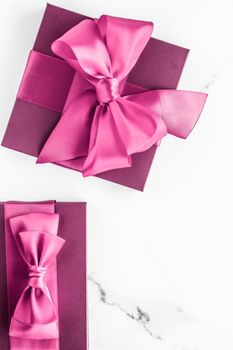 Birthday, wedding and girly branding concept - Pink gift box with silk bow on marble background, girl baby shower present and glamour fashion gift for luxury beauty brand, holiday flatlay art design