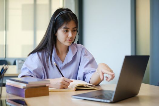 A girl practice basic course exercises by video on laptop before online class. Social distancing.stay home. New normal. Covid-19 coronavirus concept