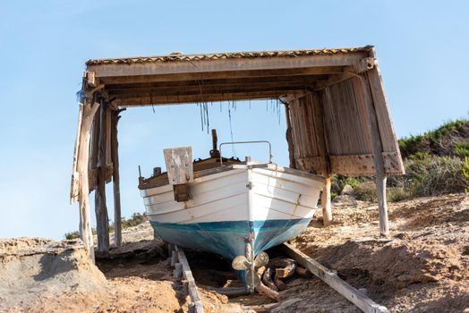 Fisherman's boat on the beach of Illetes in Formentera, Spain.