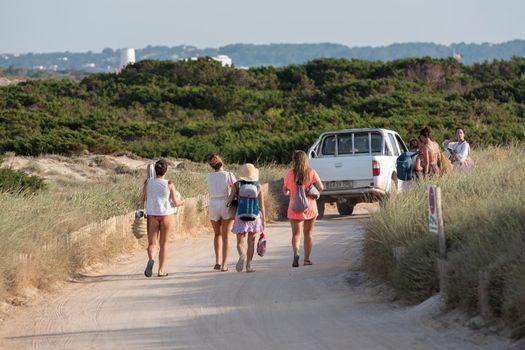 Formentera, Spain: 2021 June 13: Tourists cycling on the Illetes Beach in Formentera in Spain in times of Covid19