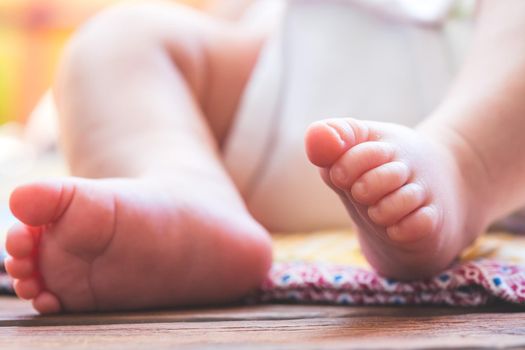 Close up of newborn baby feet, outdoors on baby blanket