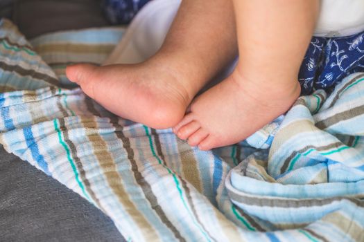 Close up of newborn baby feet on baby blanket