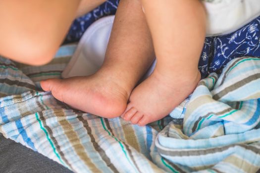 Close up of newborn baby feet on baby blanket