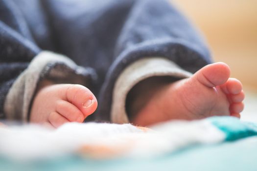 Close up of newborn baby feet on baby blanket