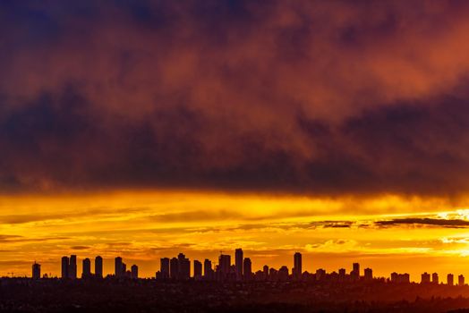 Metrotown on sunset cloudy sky background closer to the night.