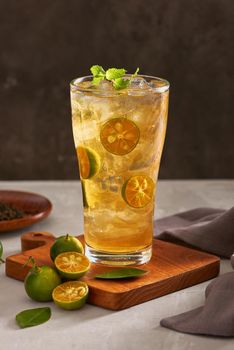 Glass of fresh drink cumquat lemonade tea.