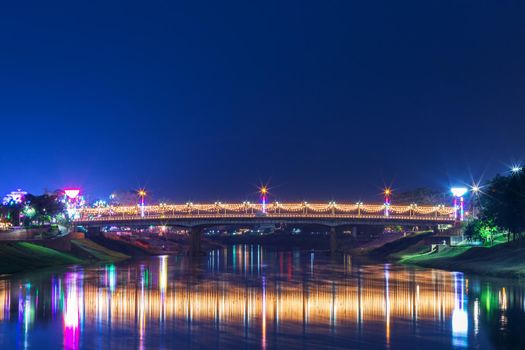 Beautiful light on the Nan River at night on the bridge (Naresuan Bridge) in Phitsanulok City,Thailand.