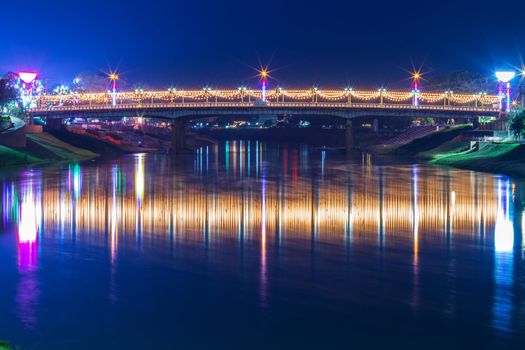 Beautiful light on the Nan River at night on the bridge (Naresuan Bridge) in Phitsanulok City,Thailand.