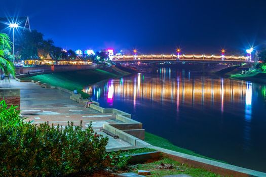 The beautiful color of the lights on  Road pathway in the park for relaxing walking jogging or ride bicycle and exercise at night in Phitsanulok City, Thailand. 