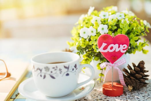 Close-up of empty notebook,spectacles and cup of coffee on Marble floor background. Love concept with heart desktop,Valentine's Day.