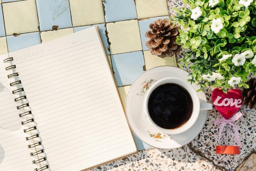 Top view image of empty notebook,spectacles and cup of coffee on Marble floor background. Love concept with heart desktop,Valentine's Day.