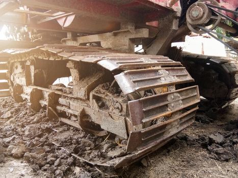 Close-up of Crawler tracks combine harvesters of The machine for harvesting from the fields.