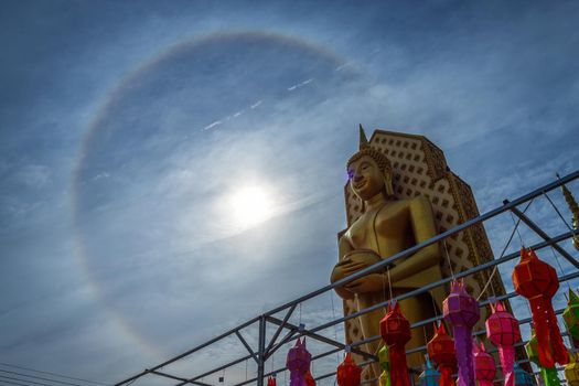 Sun halo with blue sky with Buddha statue at in Temple (Thai language:Wat Chan West) is a Buddhist temple It is a major tourist attraction Phitsanulok, Thailand