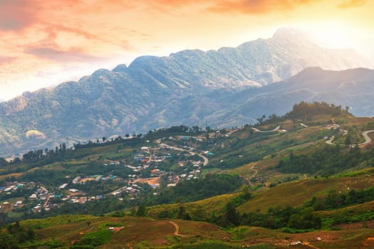 Sunset of Panoramic view mountain range with village on Nature Trail in Phu Thap Buek National Park in Phetchabun, Thailand.
