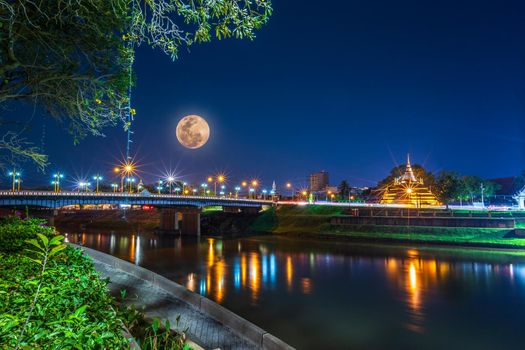 Super Full Moon over Pagoda on the Temple That is a tourist attraction, Phitsanulok, Thailand. February 2019 at night