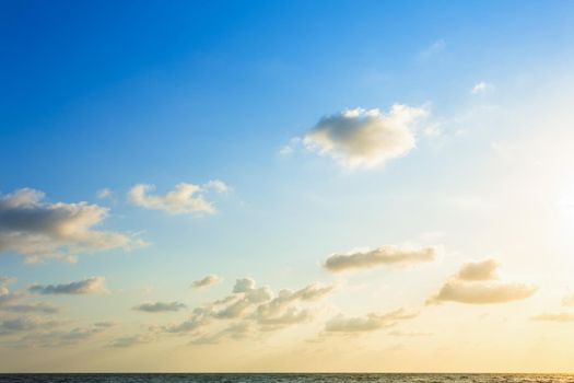 Beautiful early morning sunrise over the sea the horizon,blue sky background texture with white clouds sunset.