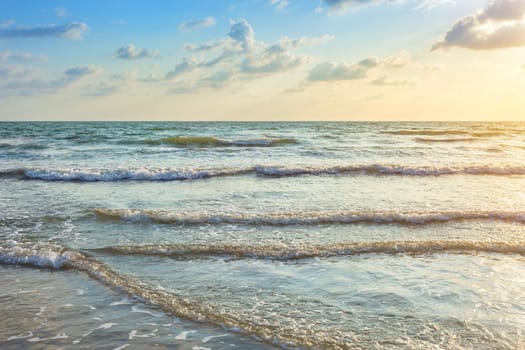 Beautiful Sunset over and Wave of the sea on the sand beach the horizon at Hat chao lao beach in Chanthaburi Thailand.