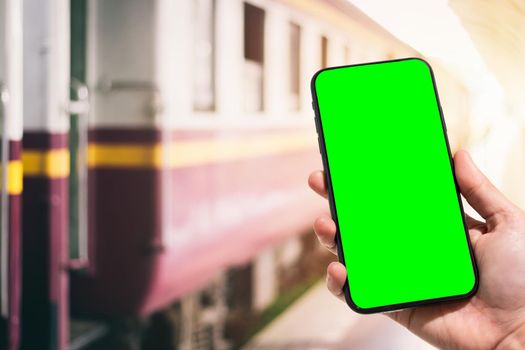Close-up of female use Hand holding smartphone blurred images touch of Abstract blur of defocused in train station the background.green screen