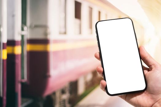 Close-up of female use Hand holding smartphone blurred images touch of Abstract blur of defocused in train station the background.