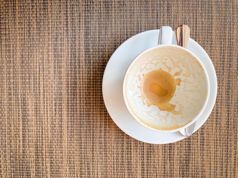 Empty coffee cup on wood desk on top view. As breakfast