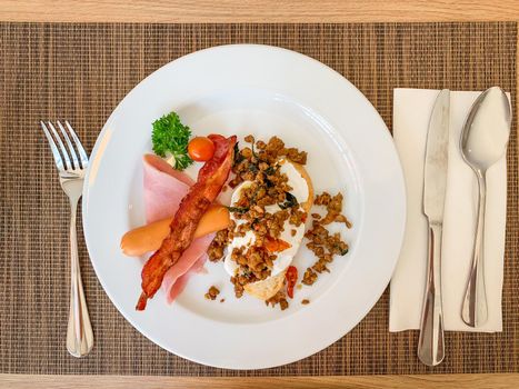 Breakfast, Kaprao fried pork with herb leaf on top Poached egg with bacon on toast, food thai.