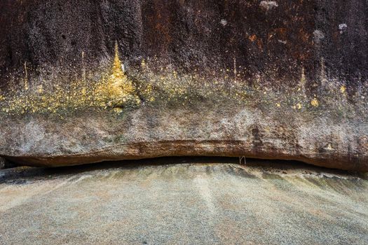 People traveling Gold Foil stick to worship The stone with the footprint of Lord Buddha at Khitchakut mountain It is a major tourist attraction Chanthaburi, Thailand.