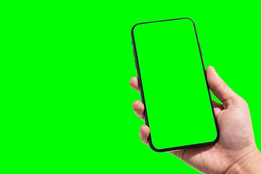Close-up of female use Hand holding smartphone blurred images touch of green screen background.
