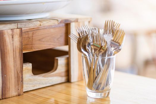 Many fork are placed with In the glass on the dining table decoration in hotel