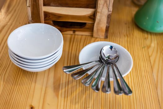 Many spoons and placed with many dishes on the dining table decoration in hotel.