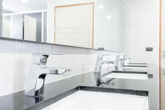 public Interior of bathroom with sink basin faucet lined up Modern design.