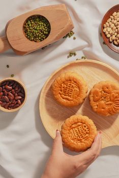 Flat lay conceptual of Mid-autumn Festival food mooncake. Text on cake mean Happiness.