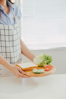 Woman apron preparing a breakfast in the kitchen