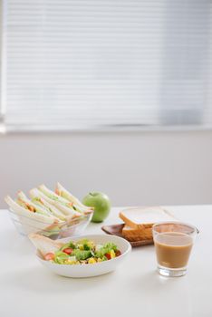 Lunch box with sandwich and fruits