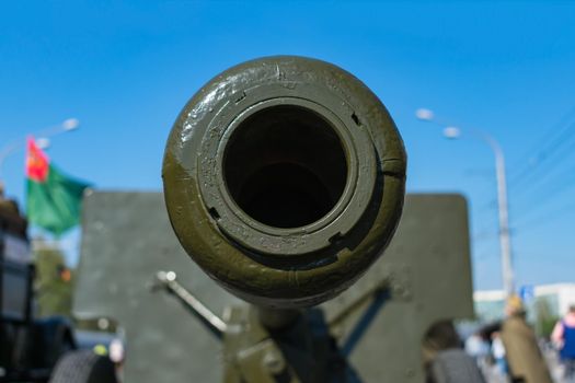 Barrel of an old artillery cannon close-up on a background of the sky. Old military equipment participating in various conflicts