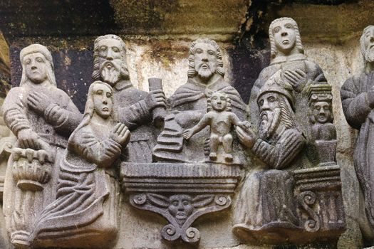 The circumcision, detail of scene on the stone Calvary in Guimiliau Parish close