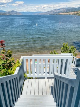 Big lake overview with wooden stairway to the beach on the shore.
