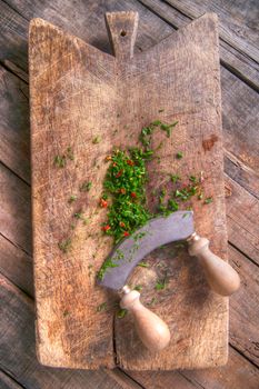 Preparation of chopped chives and chili on wooden-border