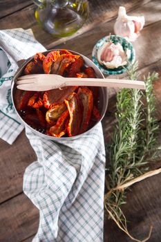 Presentation portion of dried tomatoes with rosemary in small colander