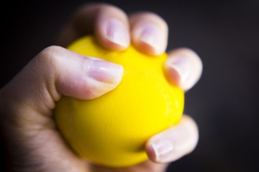 Exercises with one hand and yellow physiotherapy ball