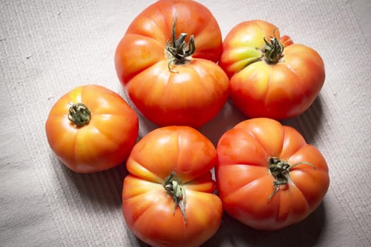 Group of uncooked raw red tomatoes. Raw food