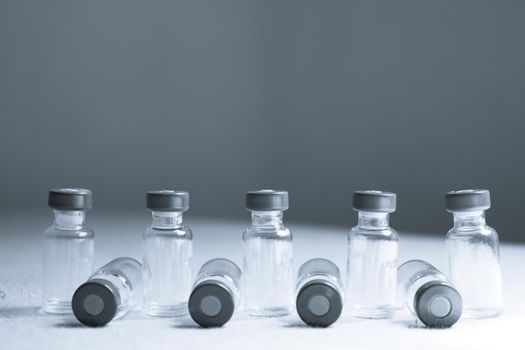 Empty glass jars of coronavirus vaccines. No people