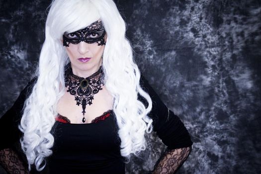 Woman disguised in gothic style for halloween party with mask