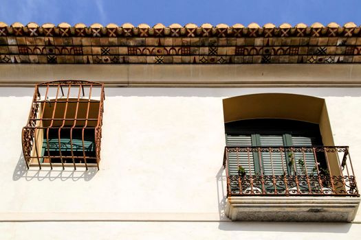 Whitewashed facade with window with forged metal grill in Altea village, Alicante, Spain