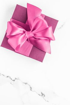 Birthday, wedding and girly branding concept - Pink gift box with silk bow on marble background, girl baby shower present and glamour fashion gift for luxury beauty brand, holiday flatlay art design