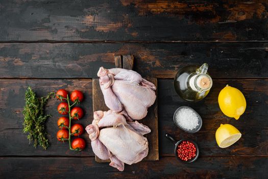 Raw coquelet chickens meat with ingredients, on old wooden table, top view with copy space for text