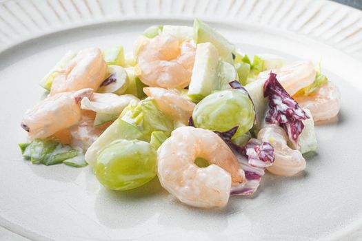 Healthy food concept, Diet salad plate. Fresh seafood salad with prawns or shrimp set , with sauce apple and grape, on gray background