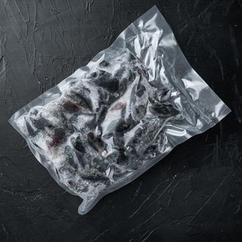 Frozen mussels in sash set, on black background, top view flat lay